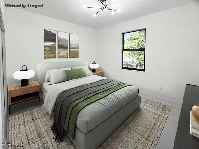 bedroom with baseboards and an inviting chandelier