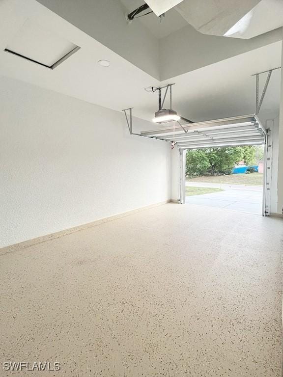 garage with a garage door opener and baseboards