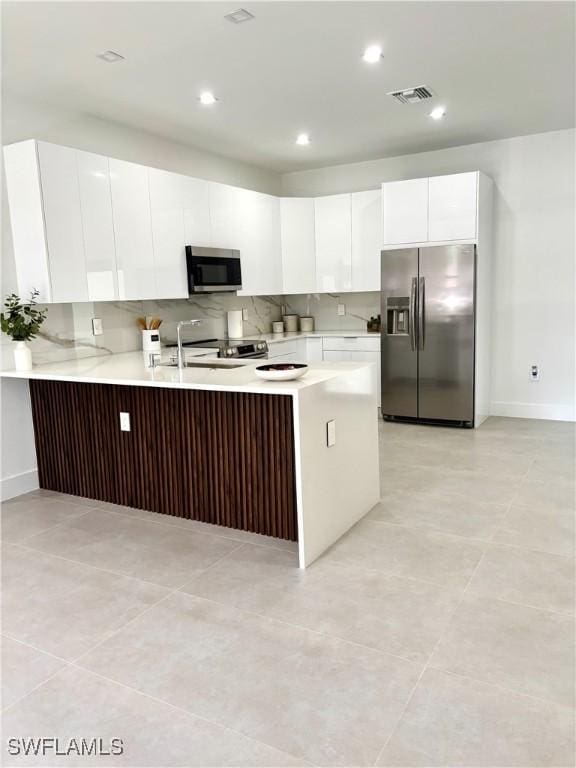 kitchen featuring visible vents, light countertops, appliances with stainless steel finishes, and white cabinetry