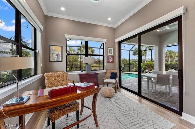 interior space with light wood finished floors, baseboards, ornamental molding, and recessed lighting