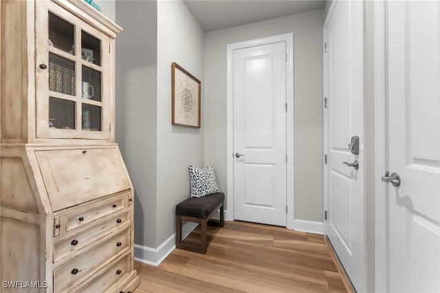 entryway with light wood-type flooring and baseboards