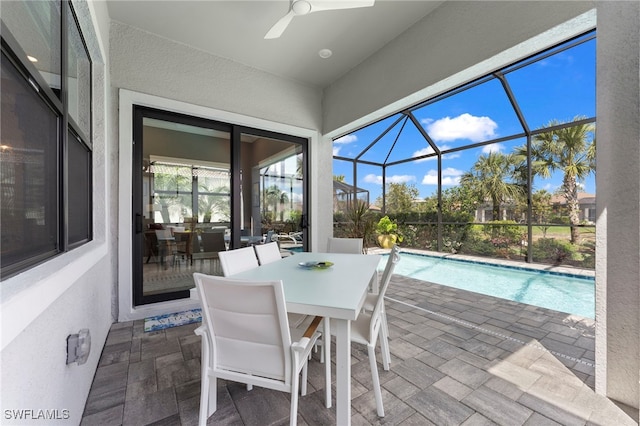 sunroom featuring ceiling fan