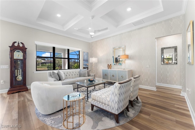 living area featuring wallpapered walls, baseboards, coffered ceiling, ornamental molding, and wood finished floors