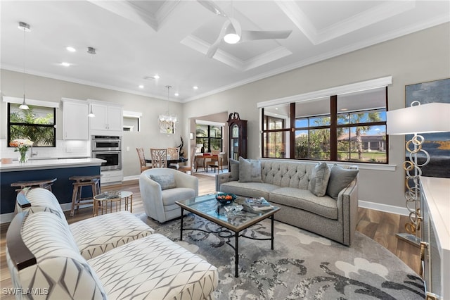 living area with ornamental molding, wood finished floors, and baseboards