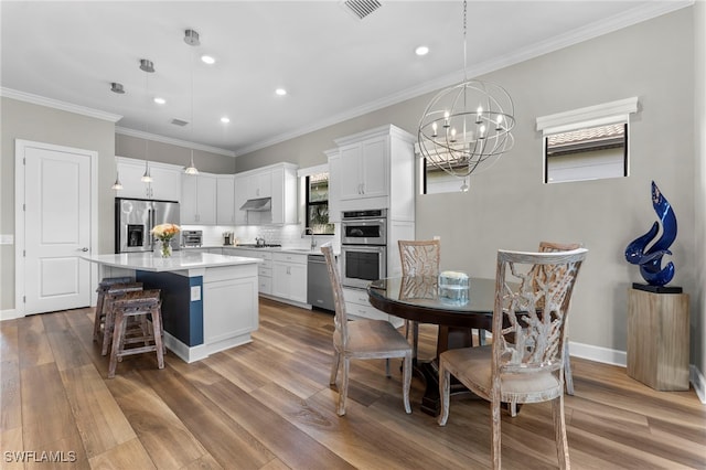 kitchen with visible vents, white cabinets, appliances with stainless steel finishes, light countertops, and under cabinet range hood