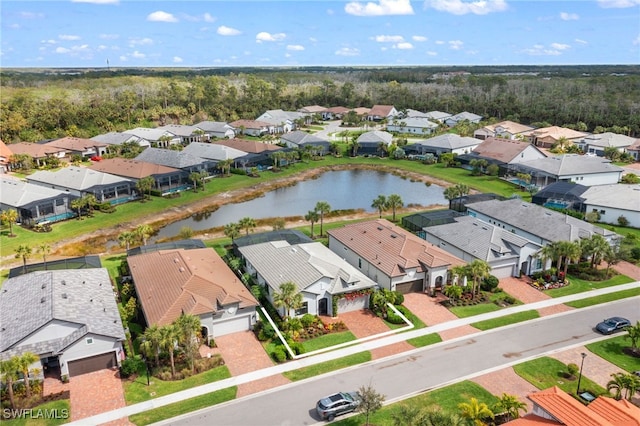 drone / aerial view featuring a residential view and a water view