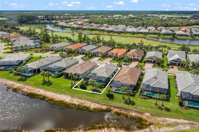 birds eye view of property featuring a water view and a residential view