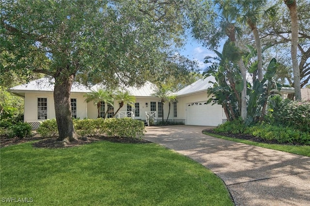 ranch-style house with a garage, a front yard, metal roof, and driveway