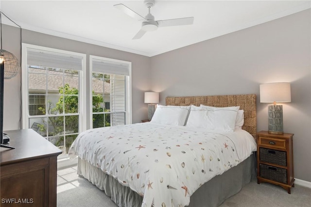 bedroom featuring light carpet, crown molding, baseboards, and a ceiling fan