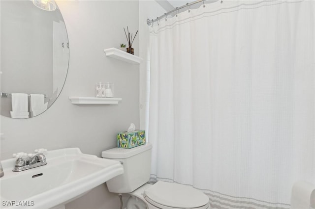 bathroom featuring toilet and a sink