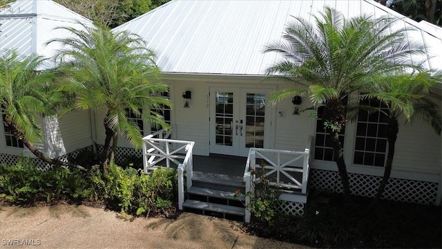 property entrance with metal roof and french doors