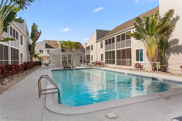 community pool featuring a patio area and a residential view