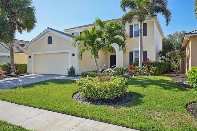 view of front of house featuring driveway, a front lawn, an attached garage, and stucco siding