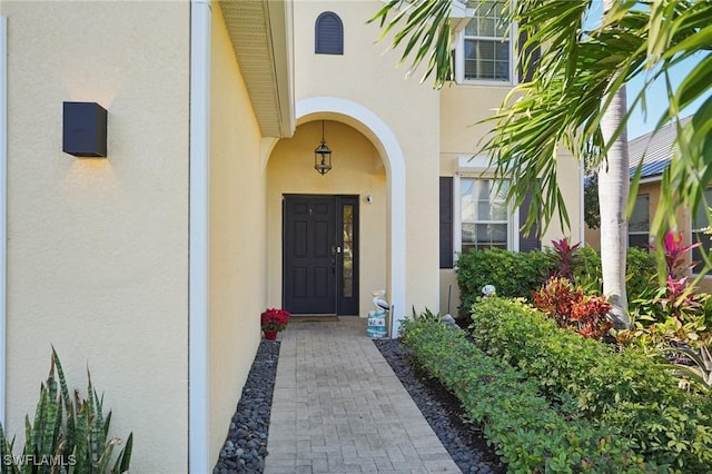 property entrance with stucco siding