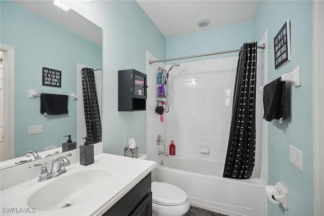 bathroom featuring shower / bath combination with curtain, vanity, and toilet