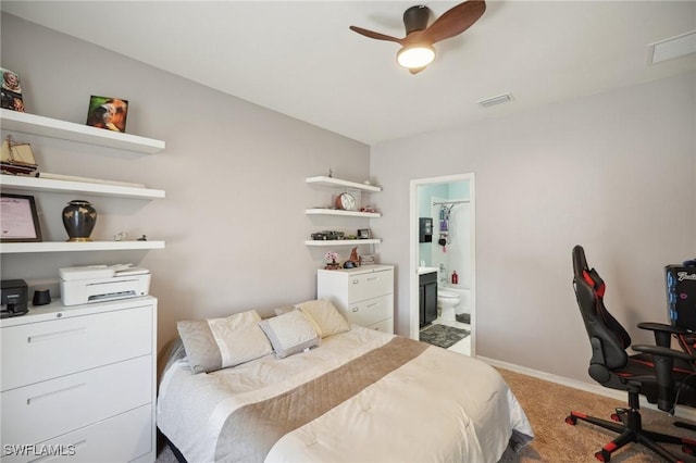 bedroom featuring carpet floors, baseboards, visible vents, and connected bathroom