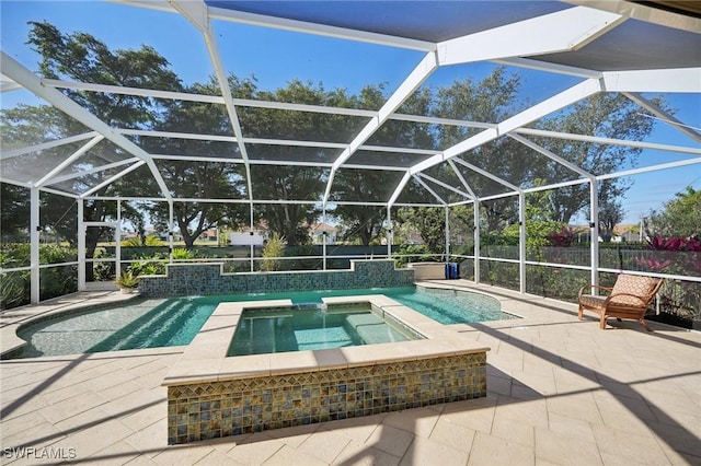 outdoor pool with glass enclosure, a patio, and an in ground hot tub