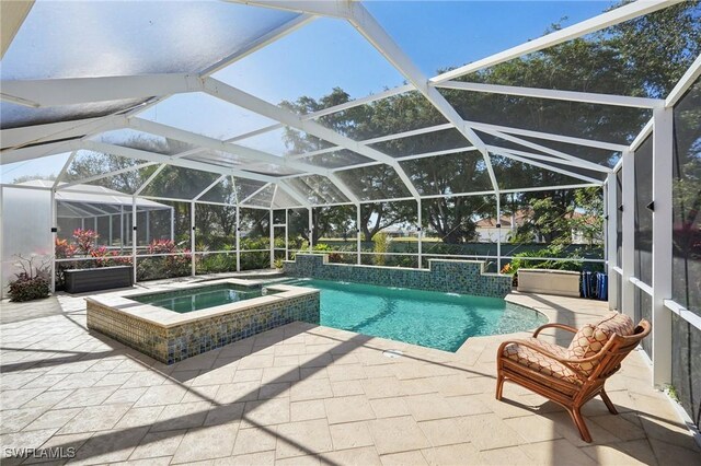 view of pool with a patio area and a pool with connected hot tub