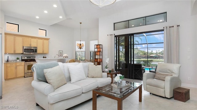 8342 Provencia Ct, Fort Myers, FL 33912 - living area with a high ceiling, recessed lighting, light tile patterned flooring, a chandelier, and baseboards