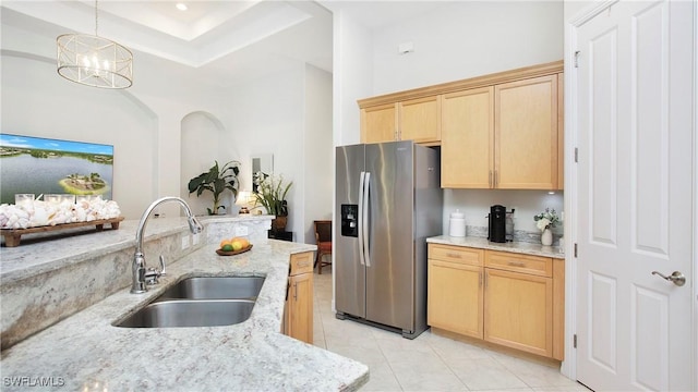 8342 Provencia Ct, Fort Myers, FL 33912 - kitchen with stainless steel refrigerator with ice dispenser, a sink, light brown cabinets, light stone countertops, and a tray ceiling