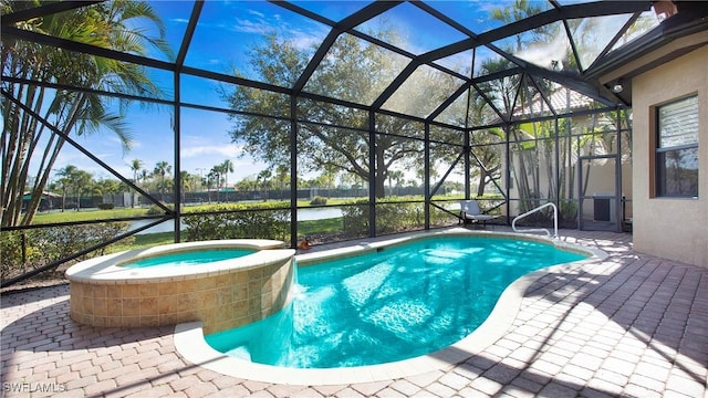 view of pool with a lanai, a pool with connected hot tub, and a patio