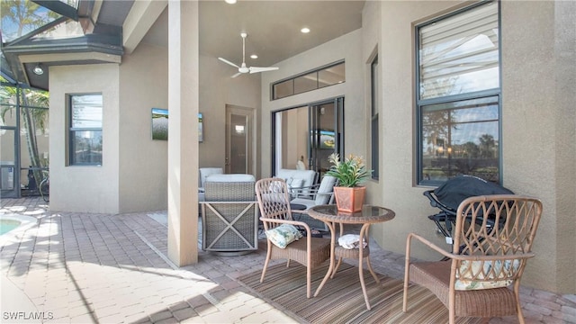 view of patio / terrace featuring ceiling fan and a lanai