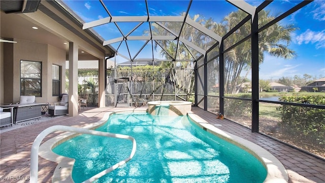 outdoor pool featuring a lanai, a patio area, and an outdoor hot tub