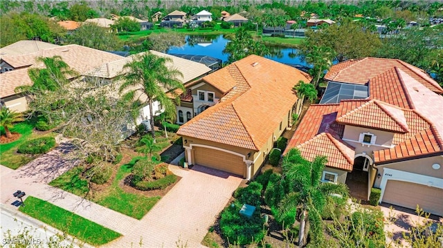 birds eye view of property with a residential view and a water view