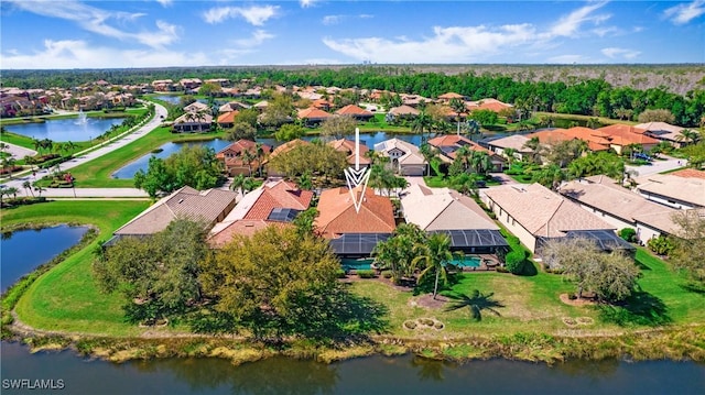 drone / aerial view featuring a water view and a residential view