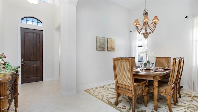 dining room featuring a healthy amount of sunlight, baseboards, and a notable chandelier