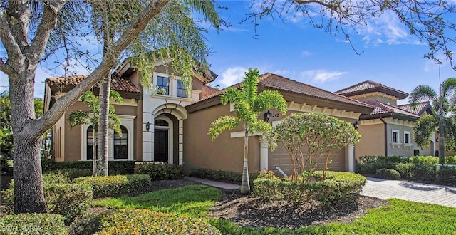 8342 Provencia Ct, Fort Myers, FL 33912 - mediterranean / spanish house with a tiled roof, an attached garage, stucco siding, and driveway