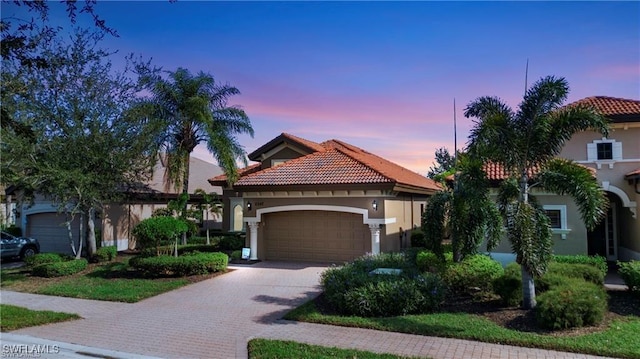 8342 Provencia Ct, Fort Myers, FL 33912 - mediterranean / spanish-style house with stucco siding, a garage, a tiled roof, and driveway