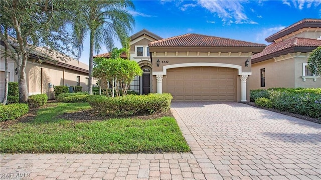 8342 Provencia Ct, Fort Myers, FL 33912 - mediterranean / spanish-style house with decorative driveway, stucco siding, an attached garage, and a tile roof