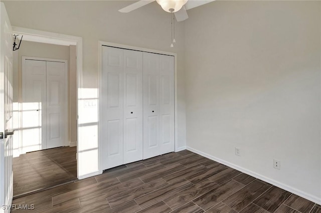 unfurnished bedroom with wood tiled floor, a closet, ceiling fan, and baseboards