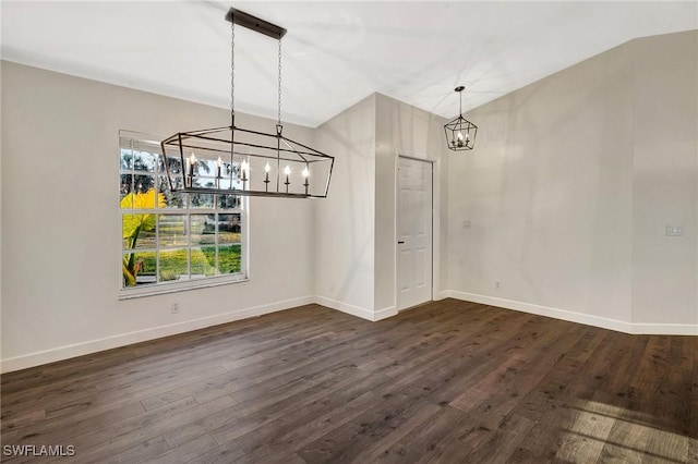 unfurnished dining area with dark wood-style floors, a chandelier, and baseboards