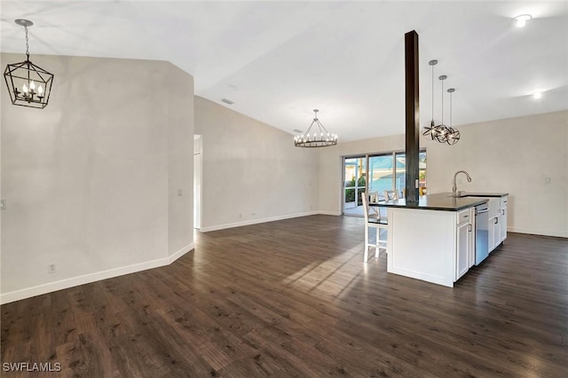 kitchen with dark countertops, an inviting chandelier, white cabinetry, and pendant lighting