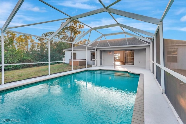 outdoor pool with a patio area and glass enclosure