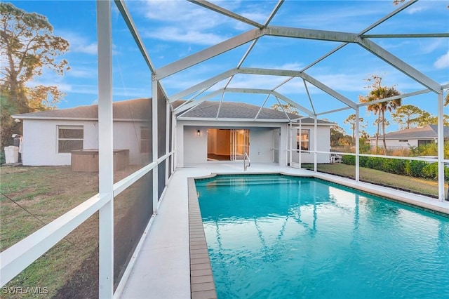 pool with glass enclosure and a patio area