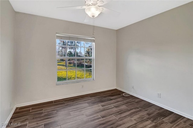 unfurnished room featuring wood tiled floor, baseboards, and ceiling fan