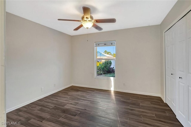 unfurnished bedroom with ceiling fan, baseboards, a closet, and wood finish floors