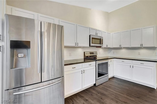 kitchen with dark countertops, white cabinetry, and stainless steel appliances