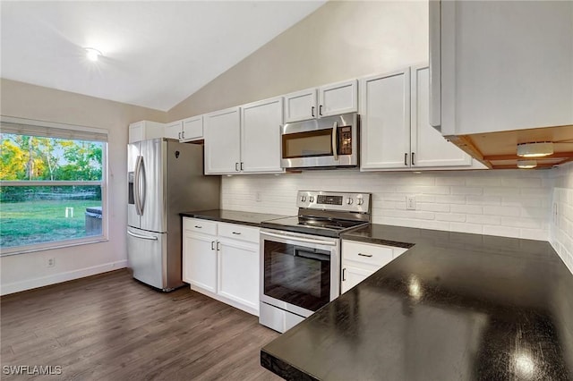 kitchen with stainless steel appliances, dark countertops, and white cabinetry