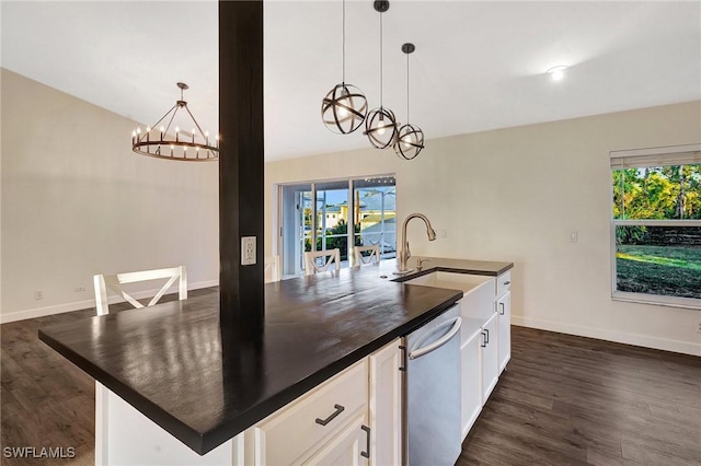 kitchen with dark countertops, white cabinets, and decorative light fixtures