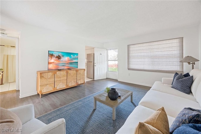 living room with dark wood-style floors and baseboards