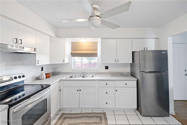 kitchen featuring stainless steel appliances, light countertops, under cabinet range hood, white cabinetry, and a sink