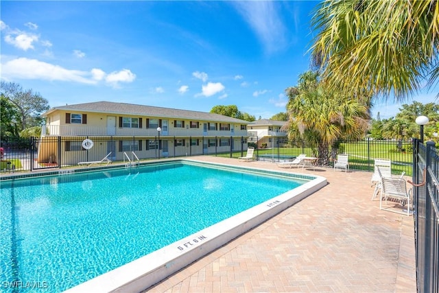 pool with fence and a patio