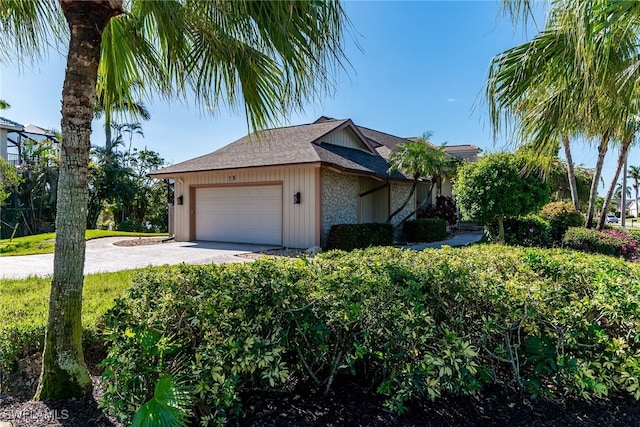 view of side of home with a garage and driveway