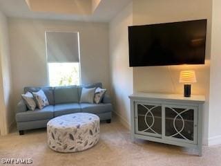 living room with baseboards and carpet flooring