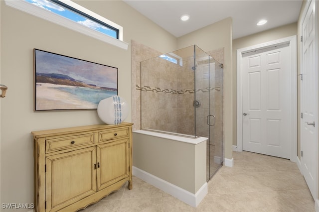 bathroom with a shower stall, baseboards, tile patterned flooring, and recessed lighting