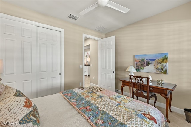 carpeted bedroom featuring lofted ceiling, a closet, visible vents, a ceiling fan, and baseboards